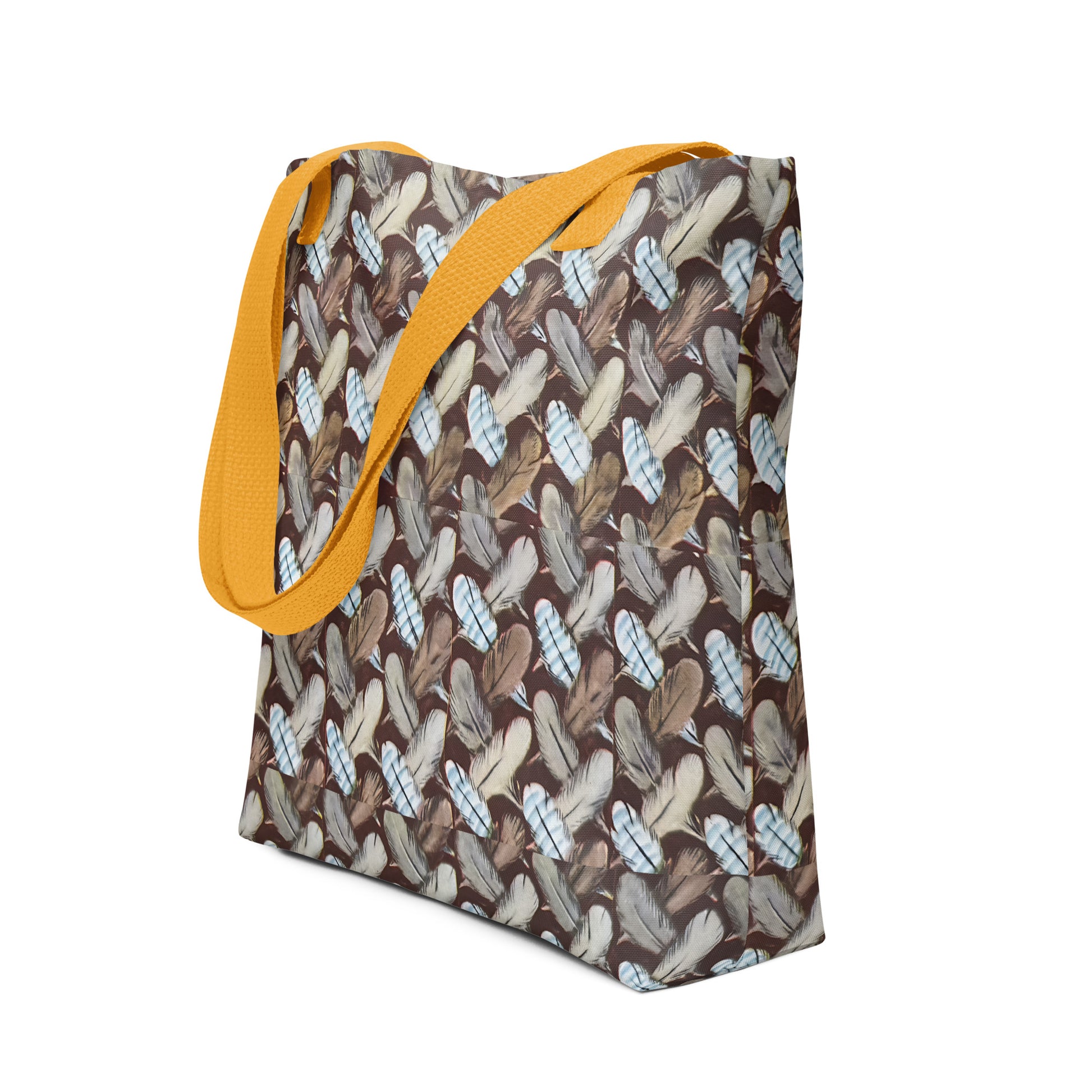 Tote bag with feather pattern and yellow strap on a white background