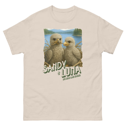 Beige t-shirt with two baby eagles and 'Sandy & Luna' text on a nature-themed background
