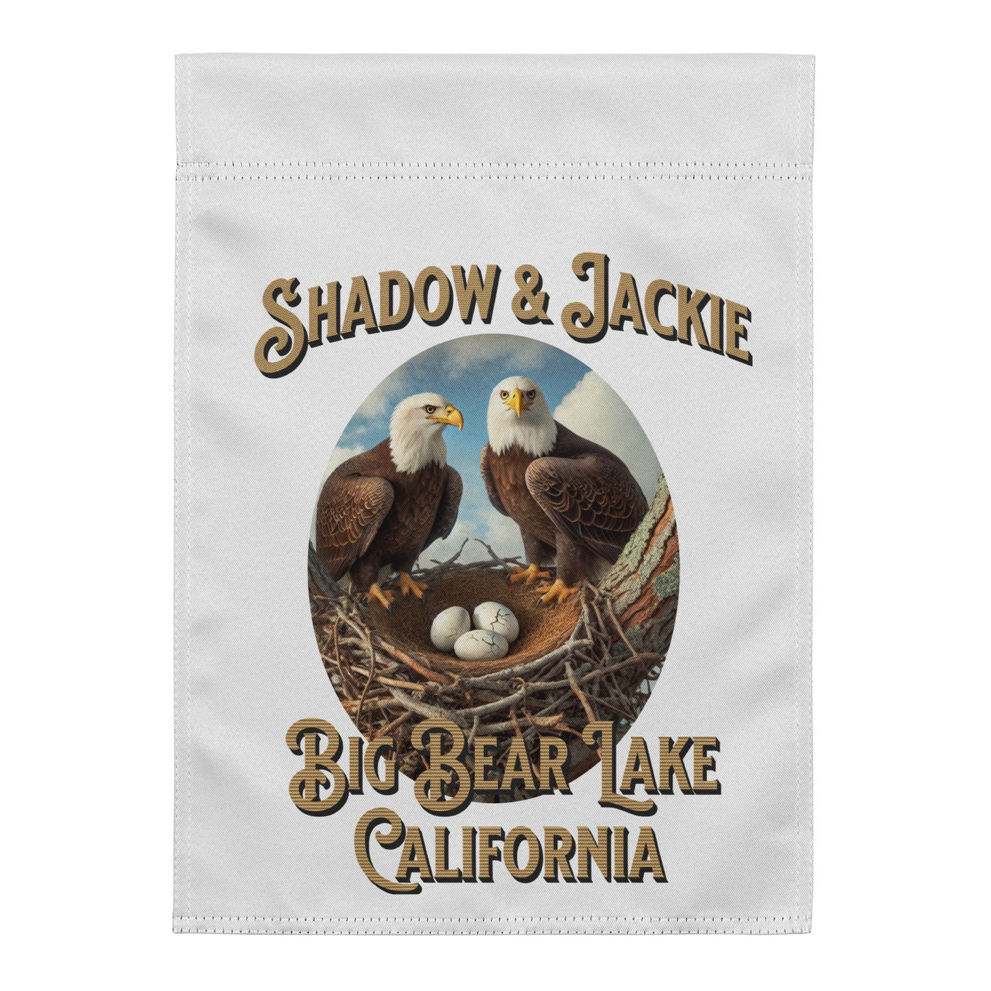 A white rectangular fabric item, likely a towel or flag, featuring a printed graphic of two bald eagles at a nest with the text 'SHADOW & JACKIE' above and 'BIG BEAR LAKE CALIFORNIA' below.