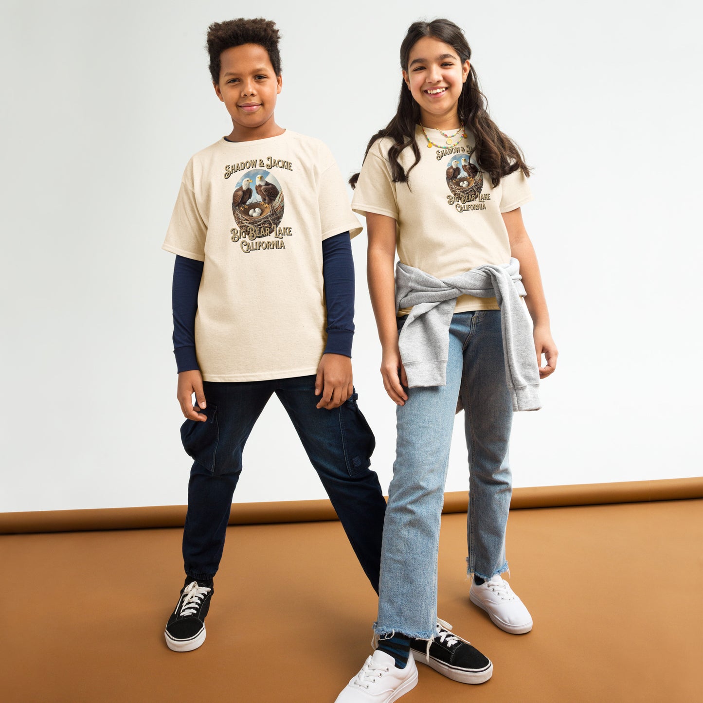 Youth t-shirt featuring Jackie and Shadow standing over their nest in Big Bear, designed for young eagle fans and nature lovers.