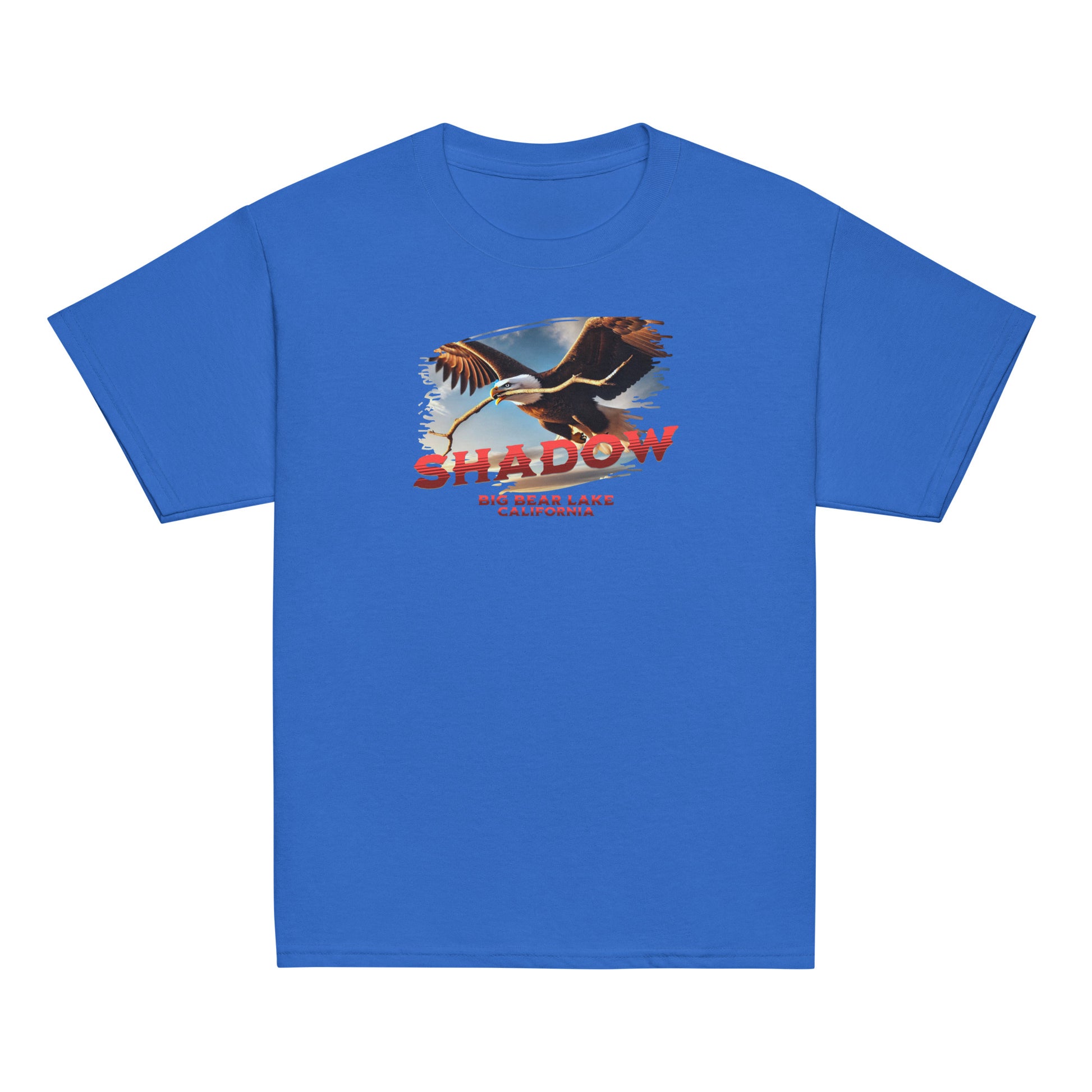 Youth t-shirt featuring Shadow the bald eagle flying with a stick in his beak over Big Bear Valley, inspired by his nest-building for Jackie.